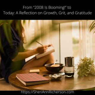 A woman journaling at a wooden table with tea, notebook, and flowers, evoking mindfulness and reflection.