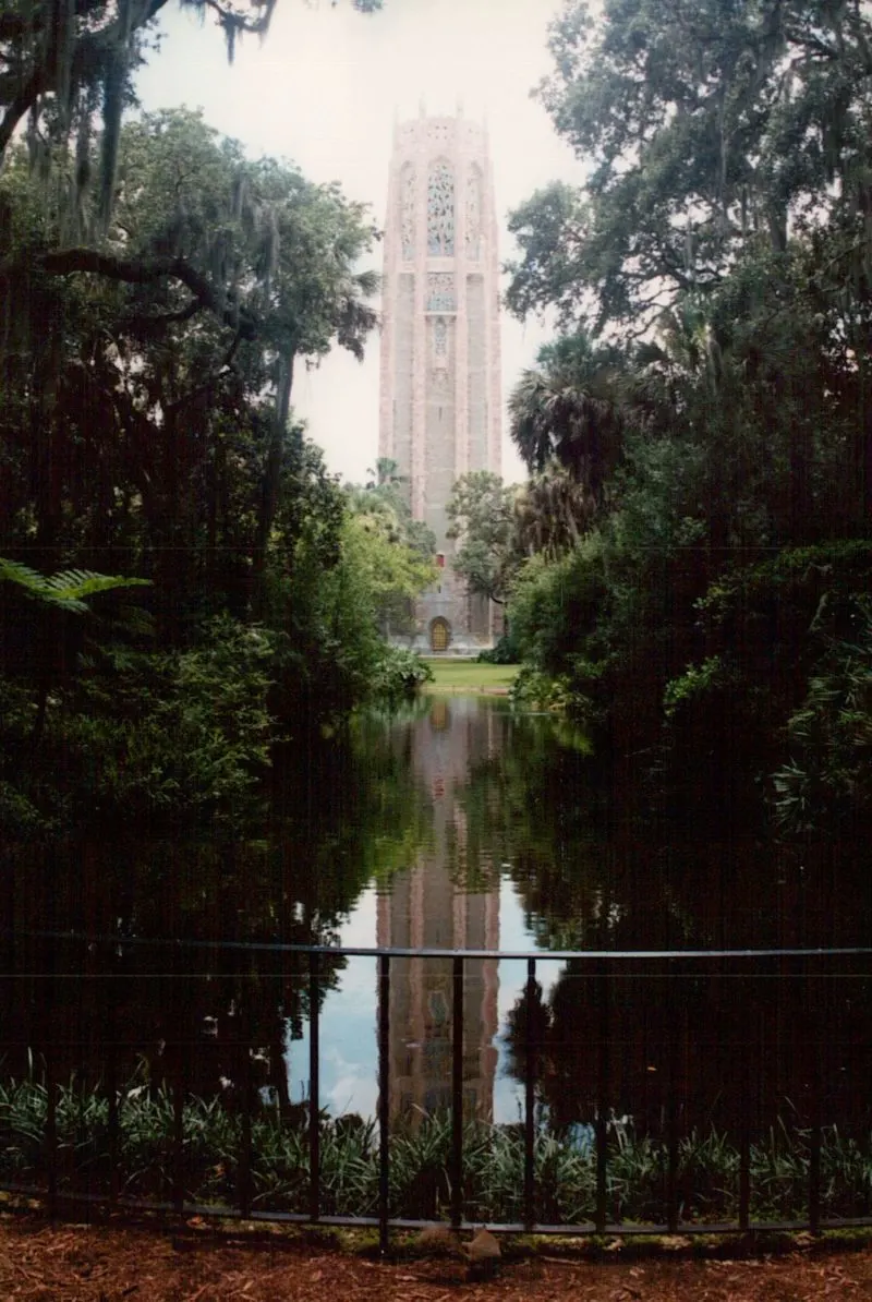 The bell tower and the reflection of the bell tower in the water.